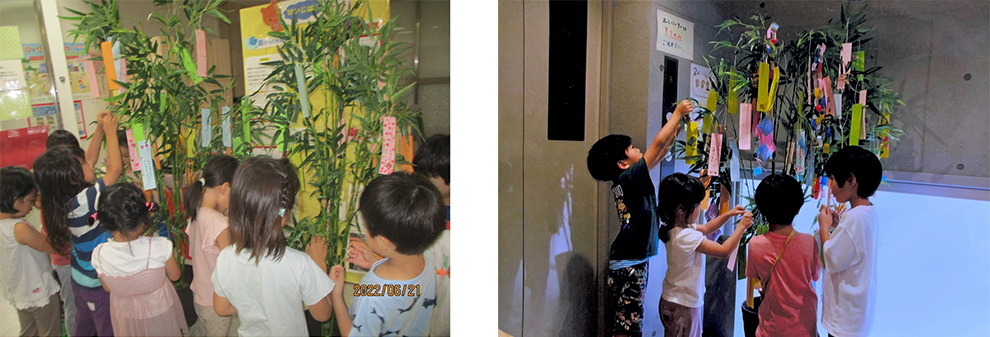 Children tie strips of paper with their wishes onto bamboo leaves